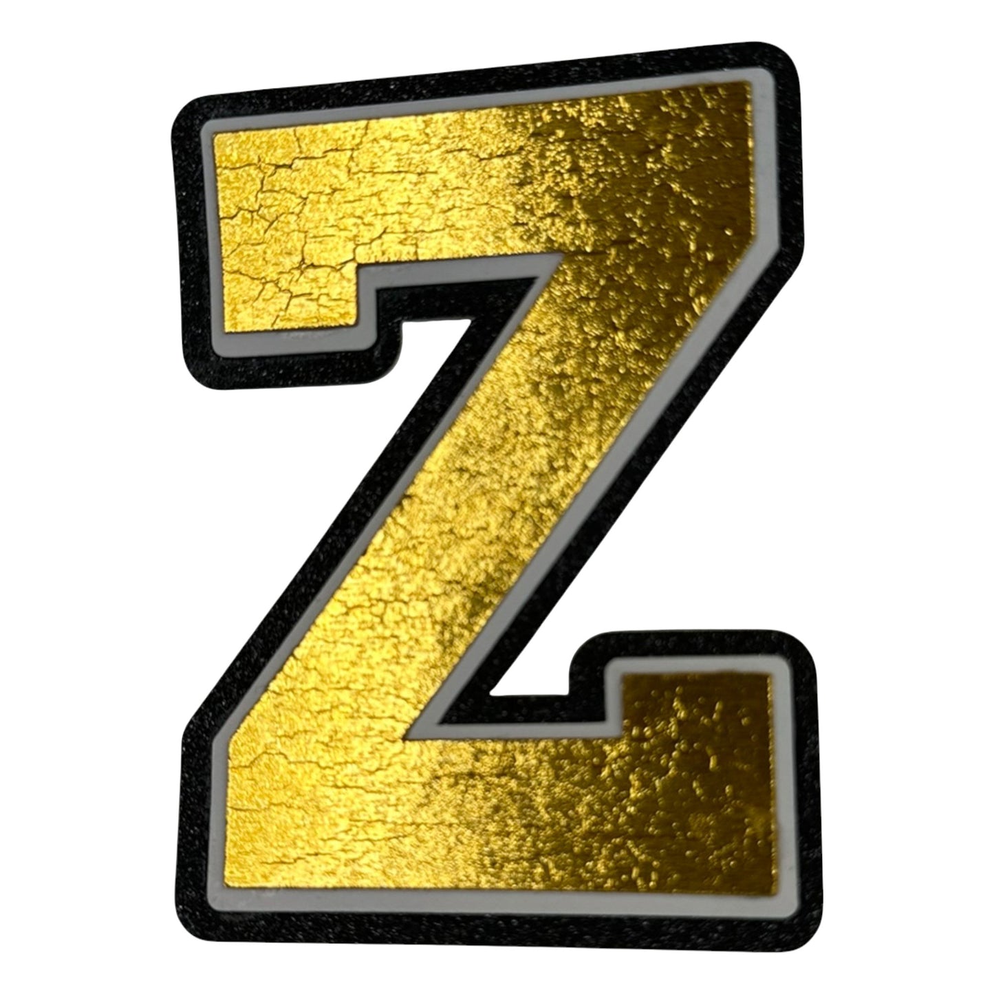 Black white and gold foil layered cardstock letter Z cutout in varsity font for homecoming mums and graduation leis.