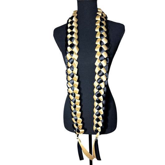 Handwoven black and gold satin ribbon graduation lei with single military braid texture.