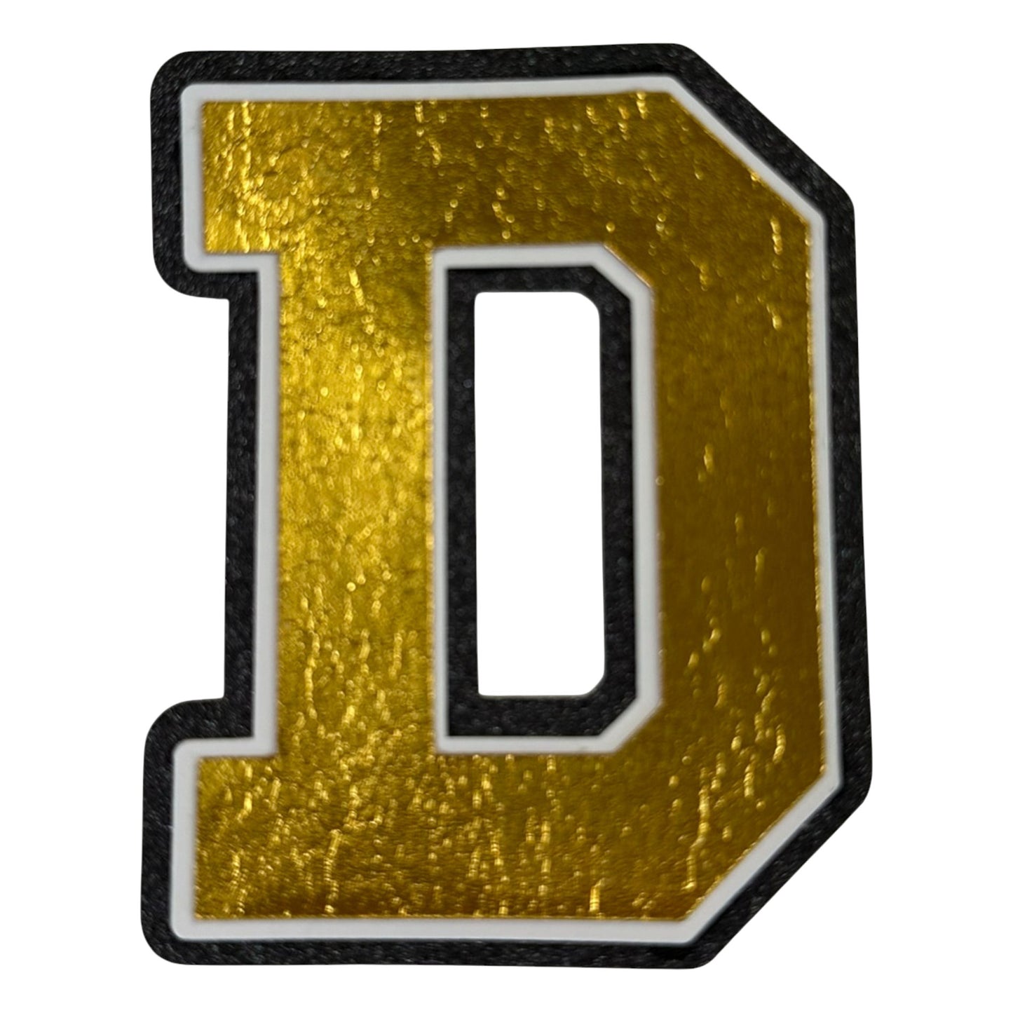 Black white and gold foil layered cardstock letter D cutout in varsity font for homecoming mums and graduation leis.
