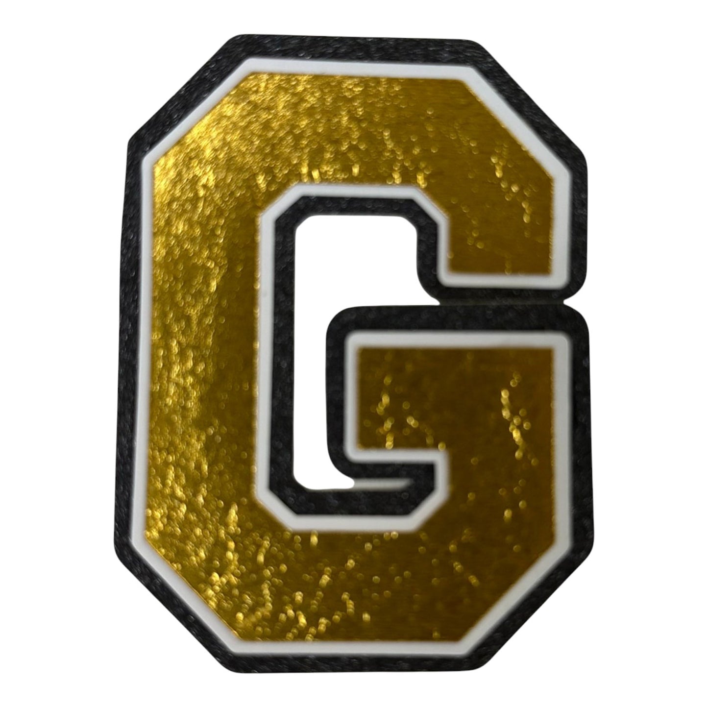 Black white and gold foil layered cardstock letter G cutout in varsity font for homecoming mums and graduation leis.