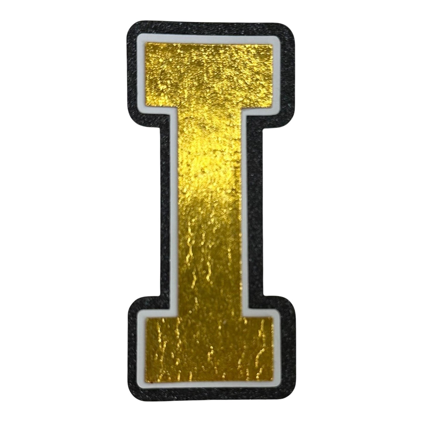 Black white and gold foil layered cardstock letter I cutout in varsity font for homecoming mums and graduation leis.