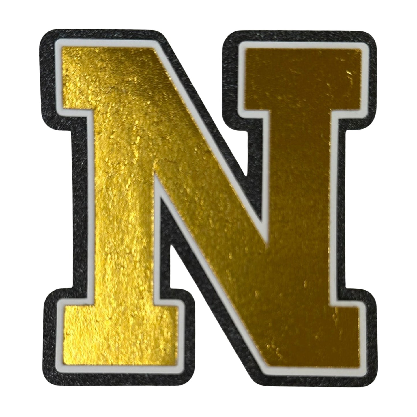 Black white and gold foil layered cardstock letter N cutout in varsity font for homecoming mums and graduation leis.