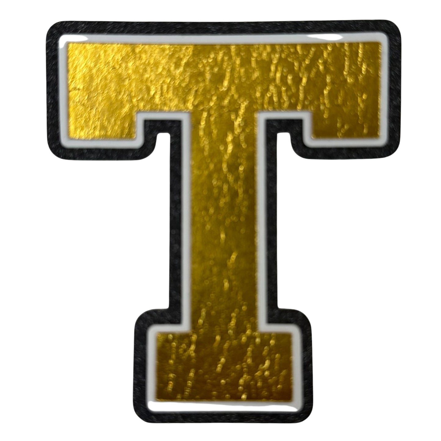 Black white and gold foil layered cardstock letter T cutout in varsity font for homecoming mums and graduation leis.
