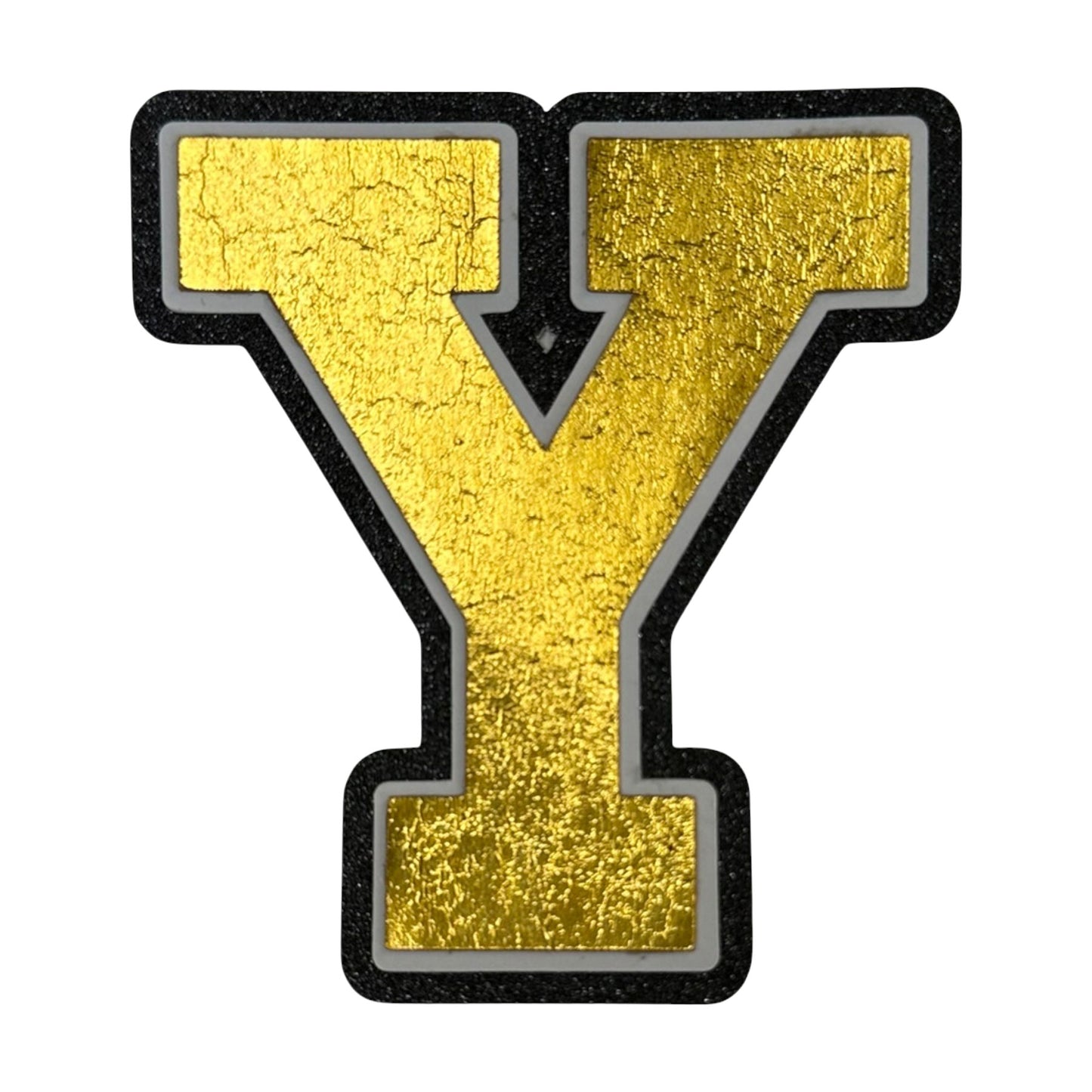 Black white and gold foil layered cardstock letter Y cutout in varsity font for homecoming mums and graduation leis.