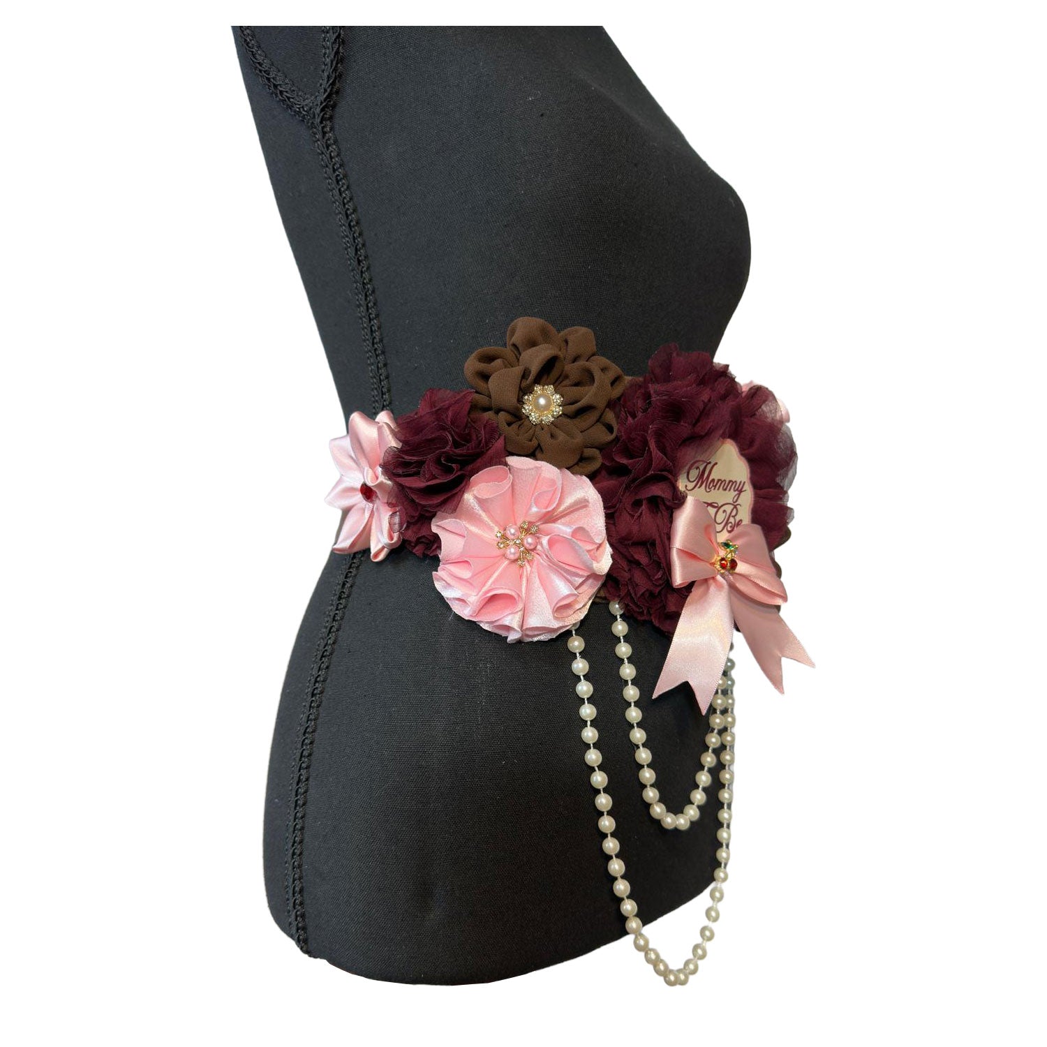 Angled right-side view of the baby shower belly sash highlighting the 3D floral textures, pearl centerpieces, and hanging pearl loops.