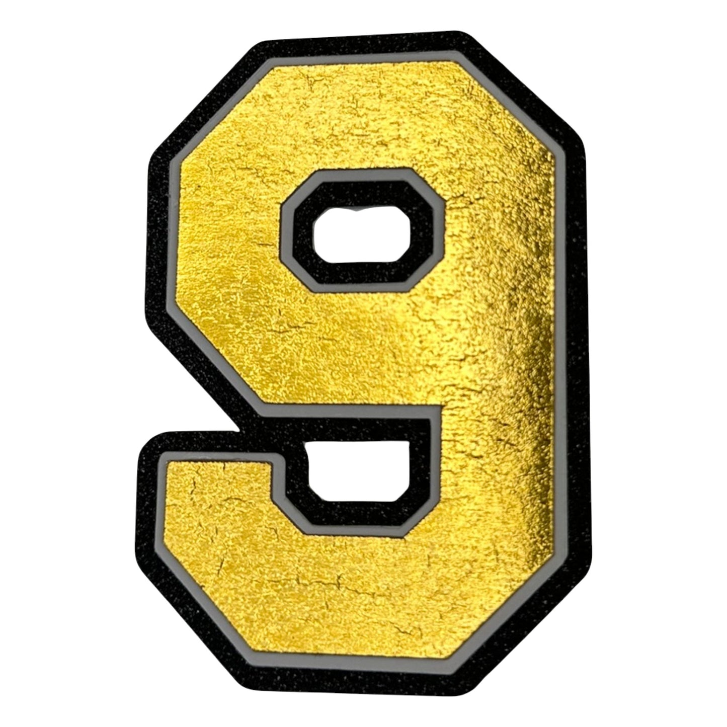 Black white and gold foil layered cardstock number 9 cutout for graduation year and jersey numbers.
