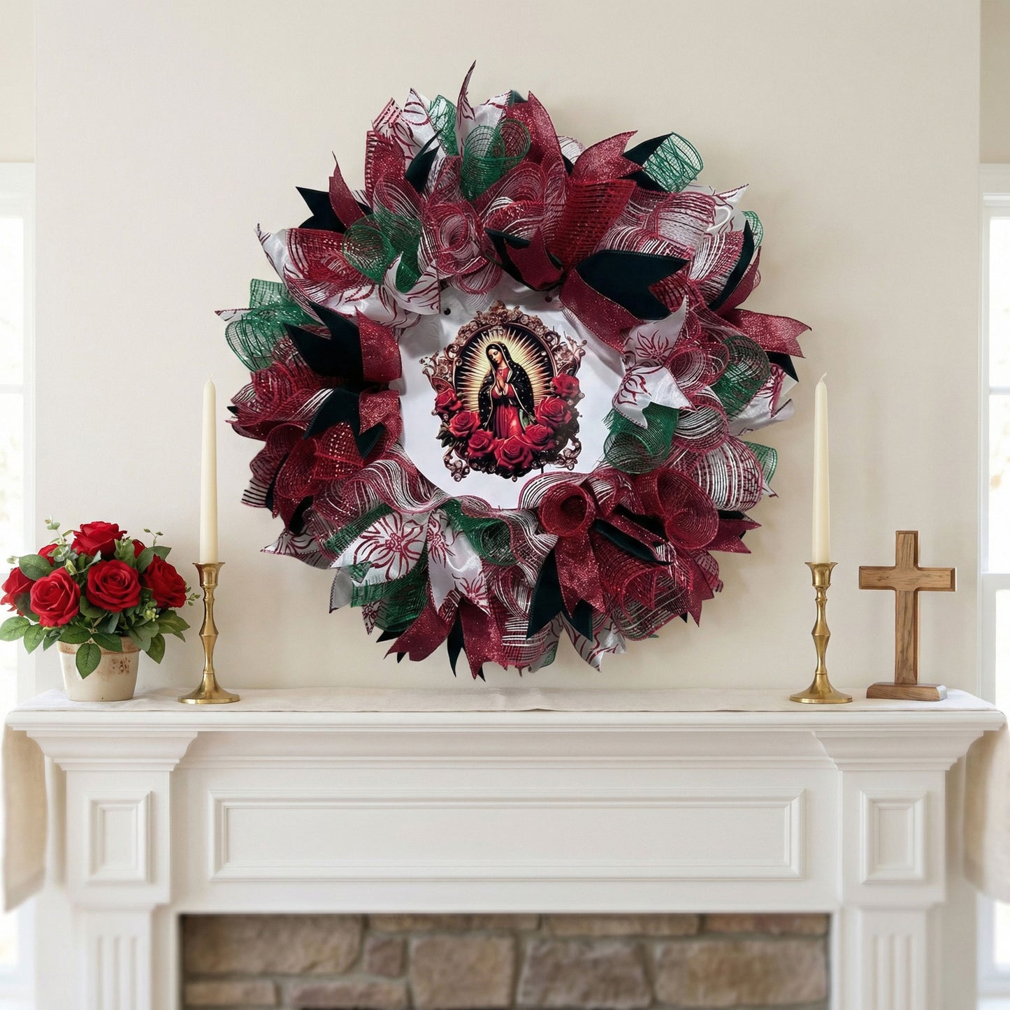 22-inch Our Lady of Guadalupe mesh wreath with red roses, green mesh, and floral ribbons over a white fireplace mantel.