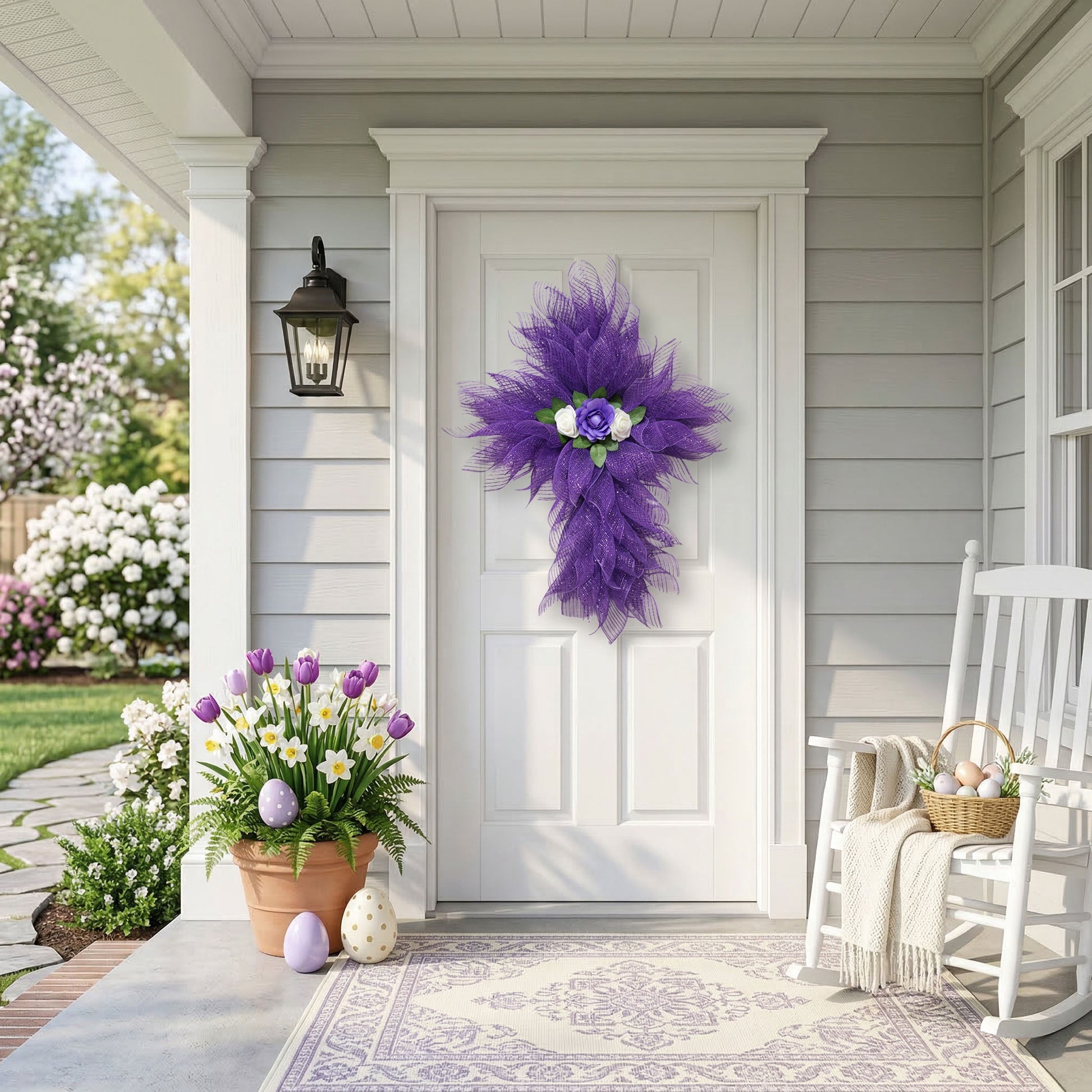 Purple deco mesh cross wreath with lavender satin rose on a white front door with Easter porch decor.