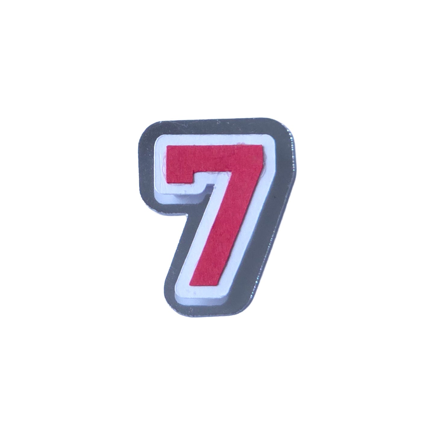 Red, white, and silver foil layered cardstock number '7' cutout in a varsity block font for homecoming mums and graduation leis.