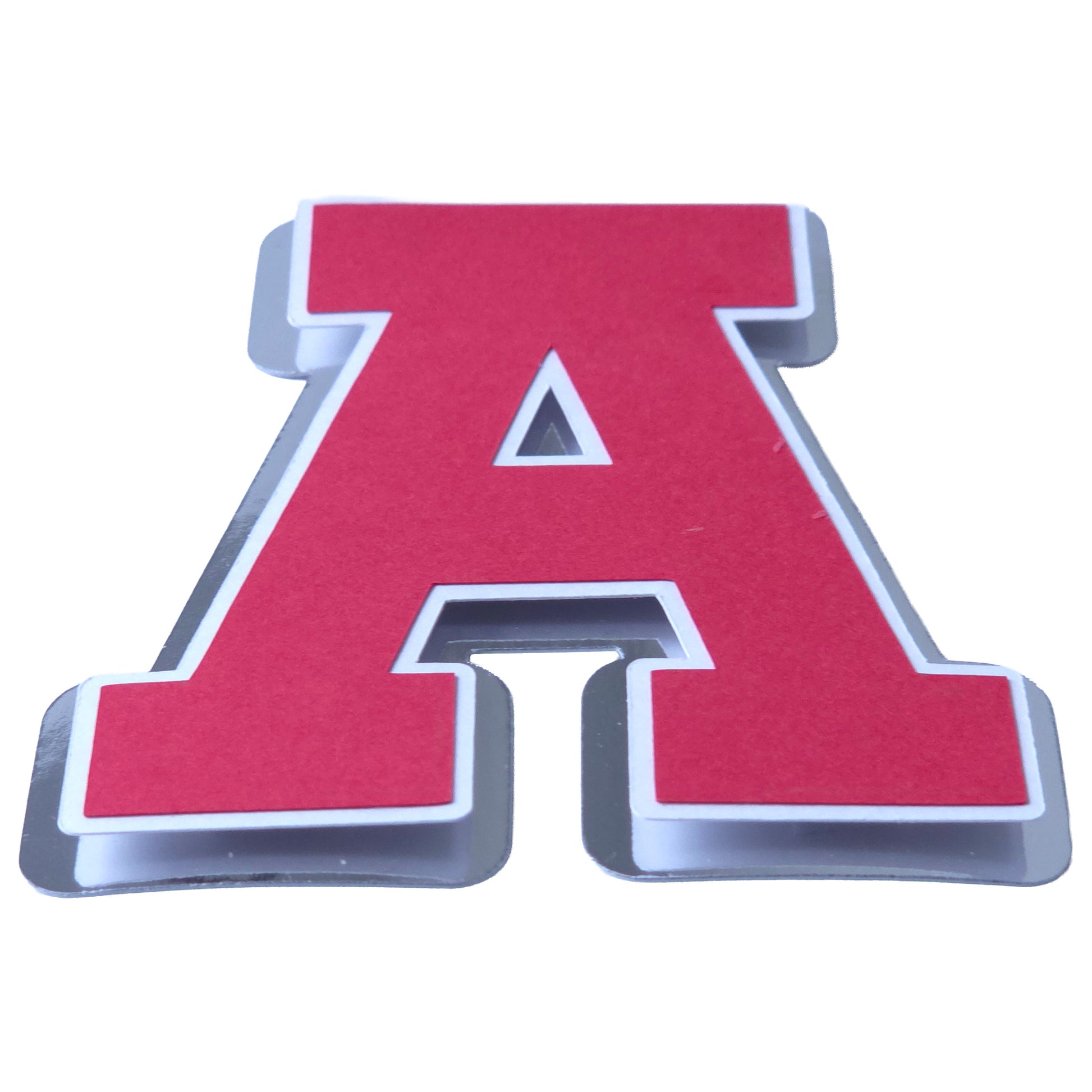 Angled side view of a layered red and silver foil cardstock letter A, highlighting the 3D effect of the metallic silver base and white offset border.