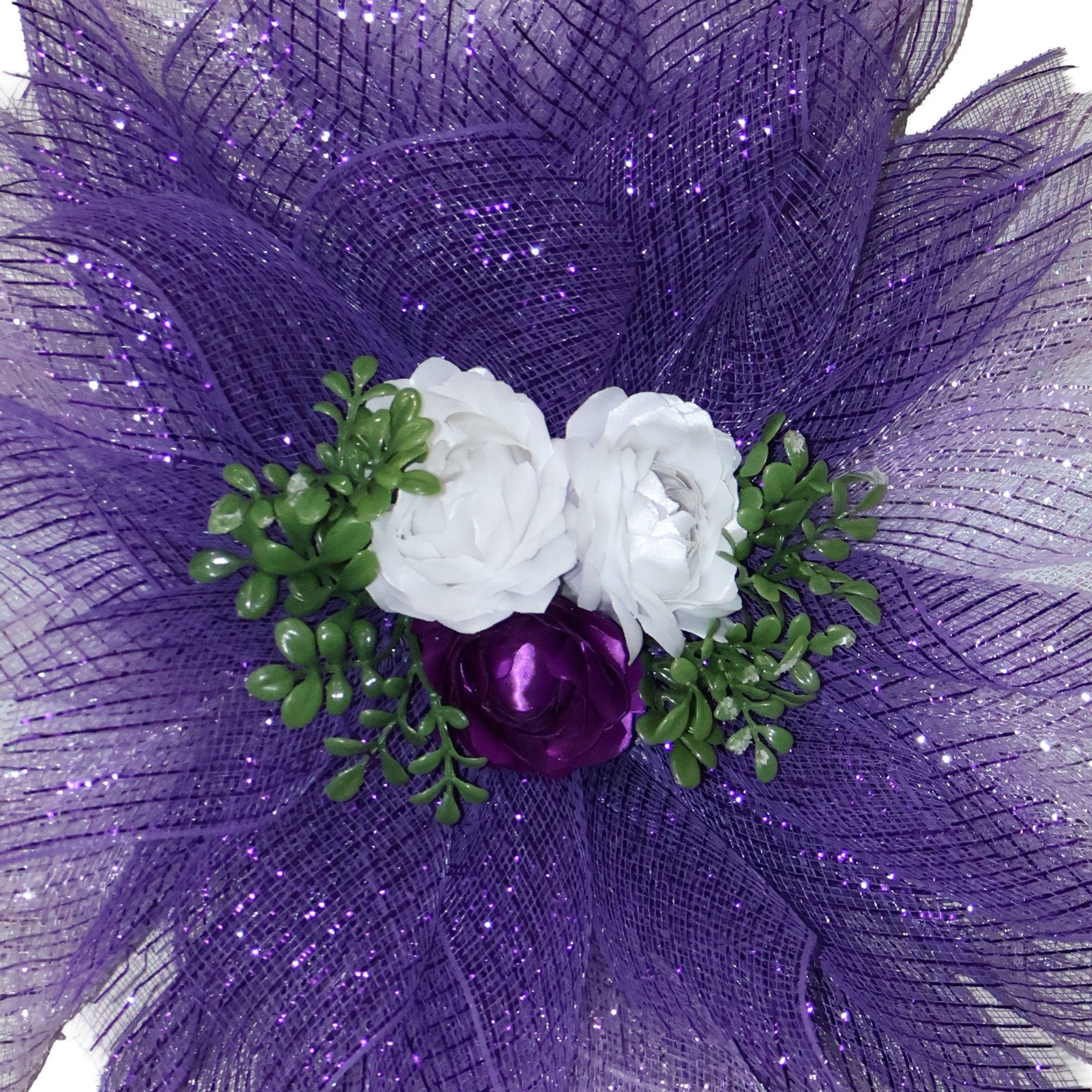 Close-up of three handmade purple and white double-satin ribbon flowers on a layered lavender deco mesh wreath.